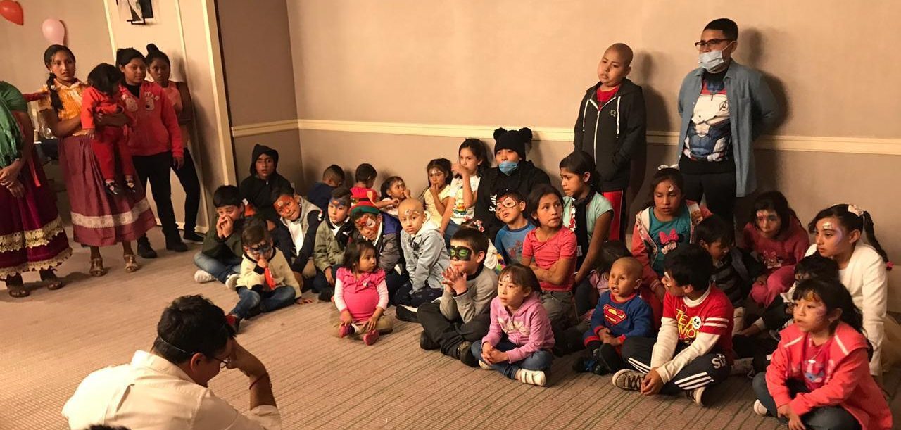 A group of children receiving care through Banco de Tapitas sit for a photo.