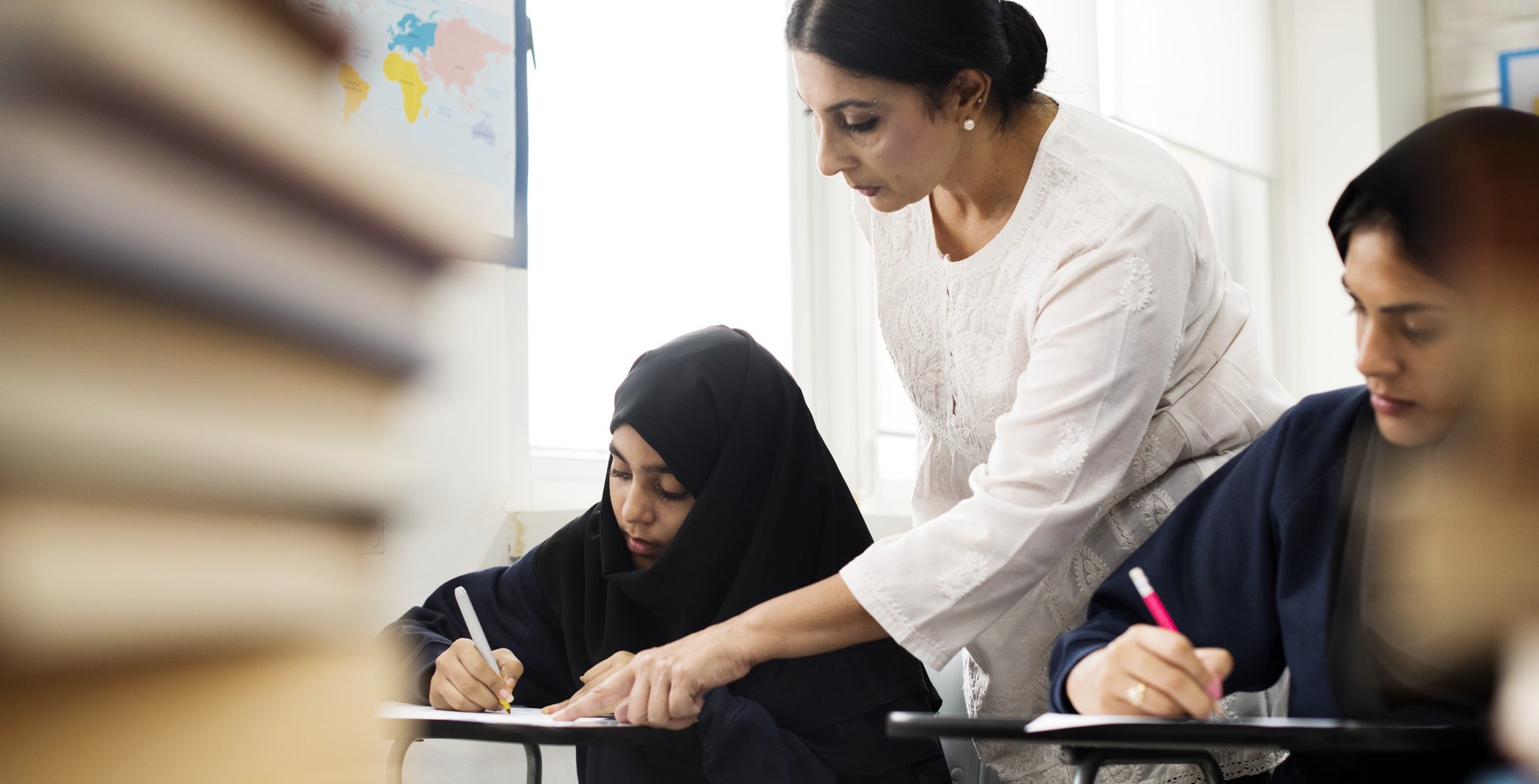 Diverse Muslim girls studying in classroom